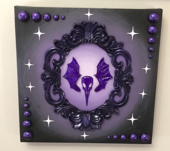 Purple bird skull framed in ornate gothic wall art